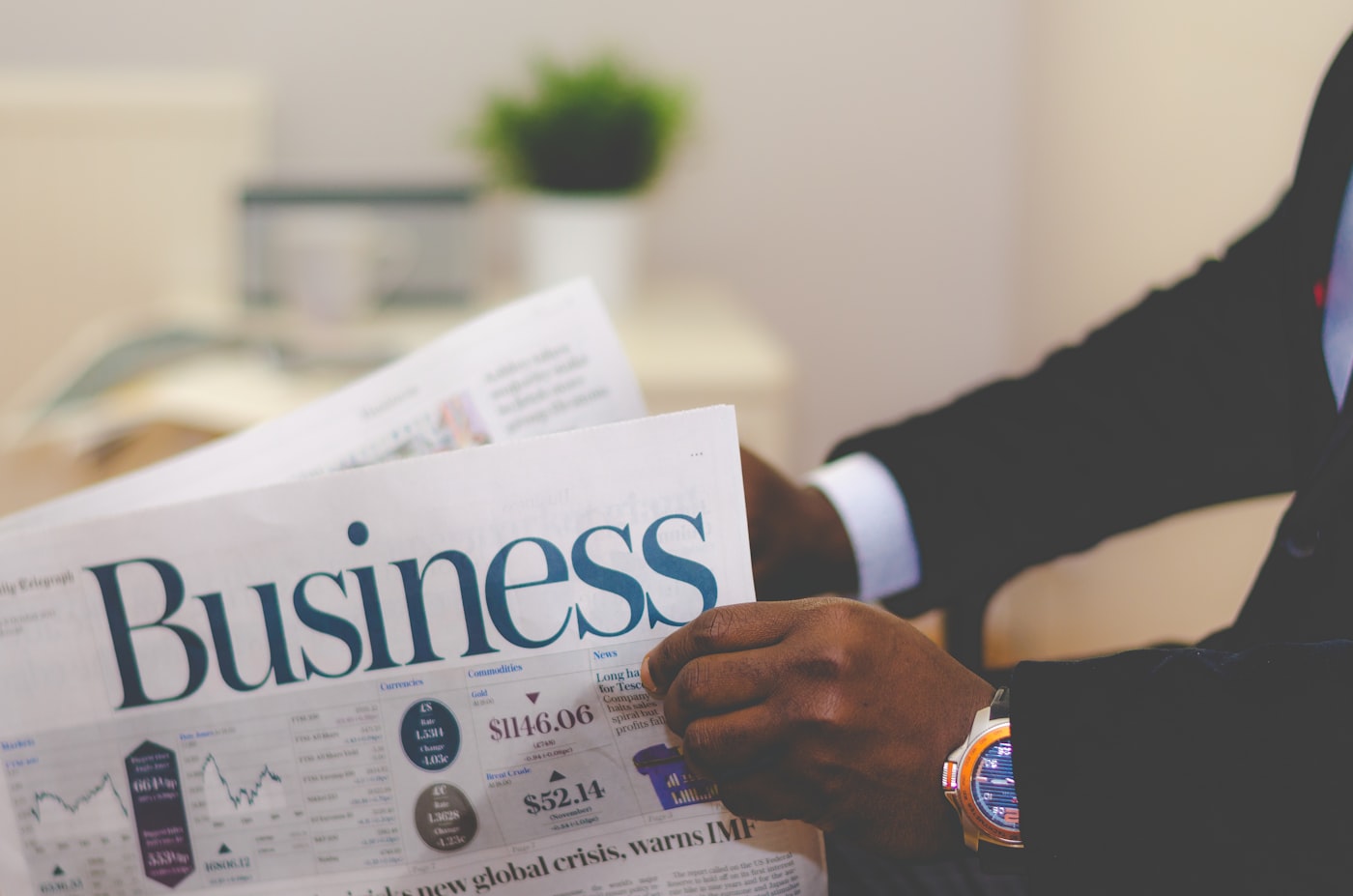 A business newspaper open on a desk