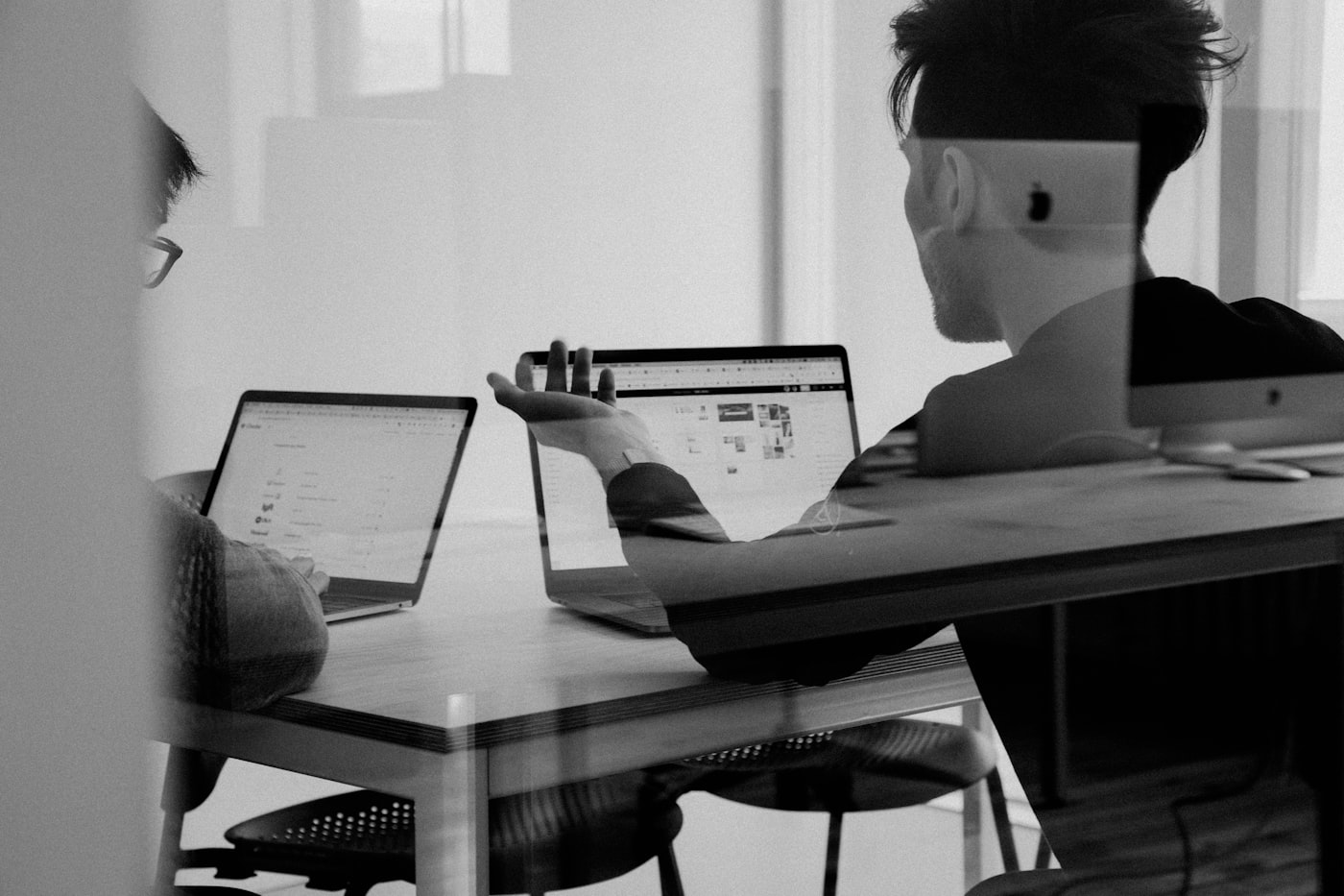 A tax professional working at a desk with multiple screens