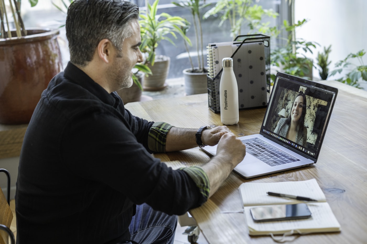A professional reviewing documents during a video call from a home office