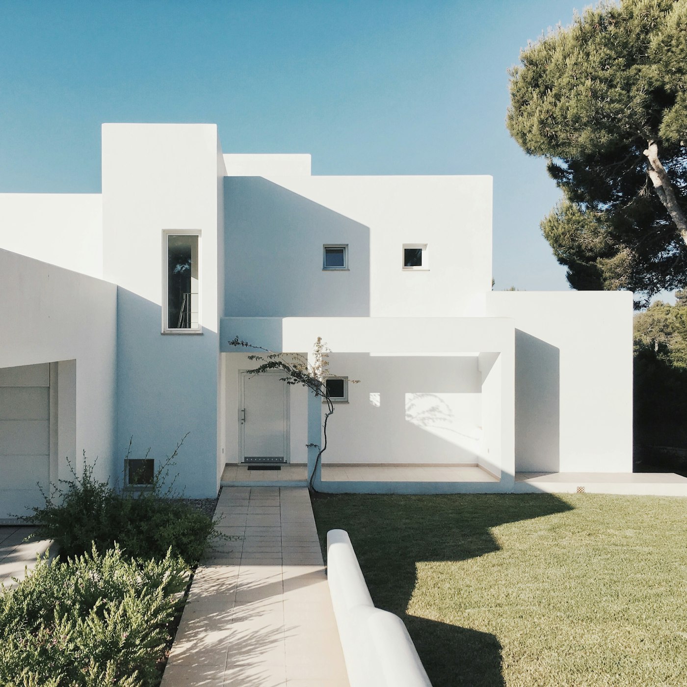 A modern white residential property with clean lines